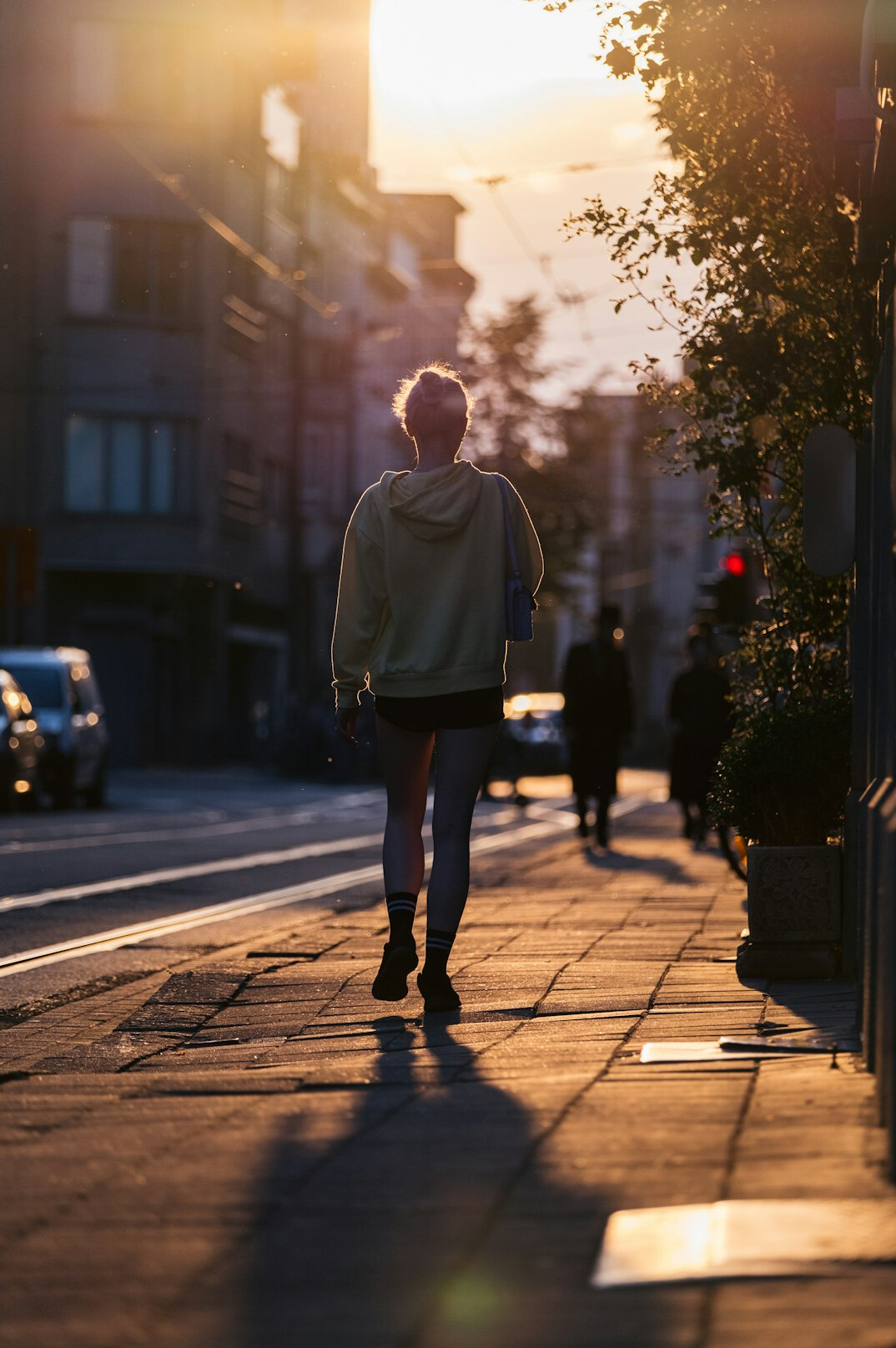 woman walking alone on street at dusk